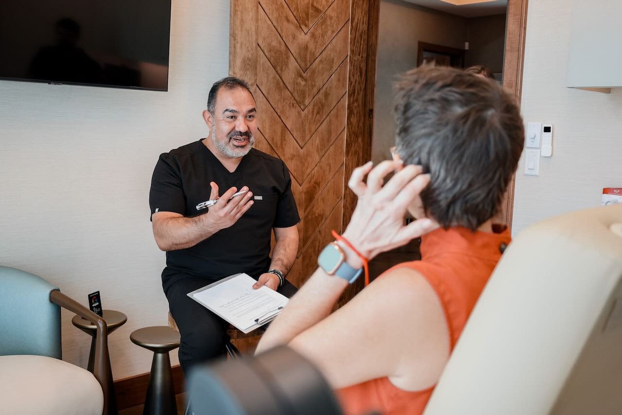 Healthcare professional discussing medical weight loss options with patient at Thrive Medicine Clinic, emphasizing individualized support for hormonal changes and metabolic health.