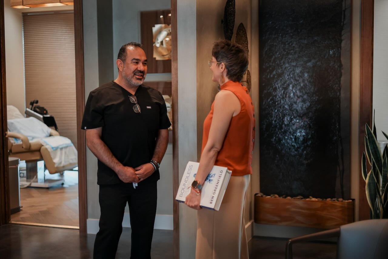 Medical professional and patient consulting in a modern clinic setting, discussing penile enhancement options, with focus on personalized care and treatment suitability.