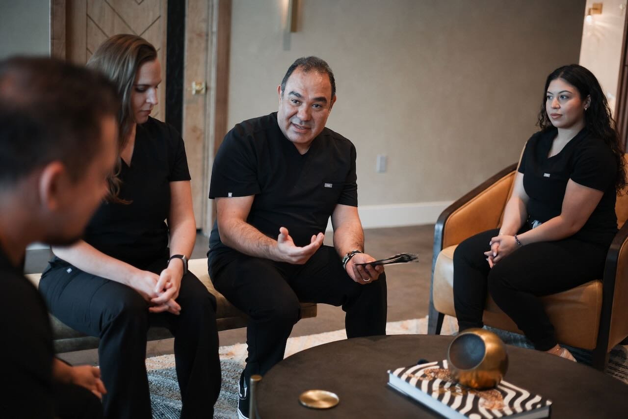 Healthcare professionals discussing the P-Long Protocol in a consultation setting, emphasizing patient safety and wellness at Thrive Medicine Clinic.