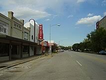 Street view of Houston with storefronts, emphasizing local businesses and community atmosphere.